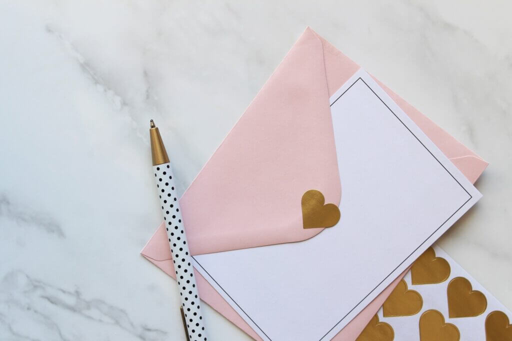 Pink and white stationary with gold heart stickers