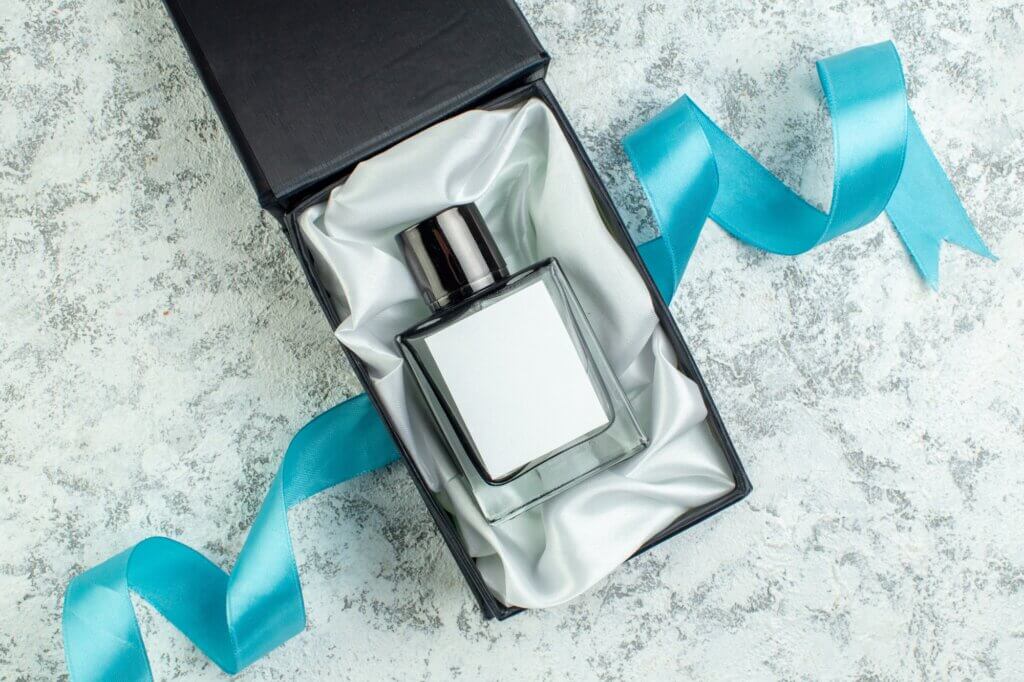 top view perfume bottle in perfume box on grey table free space