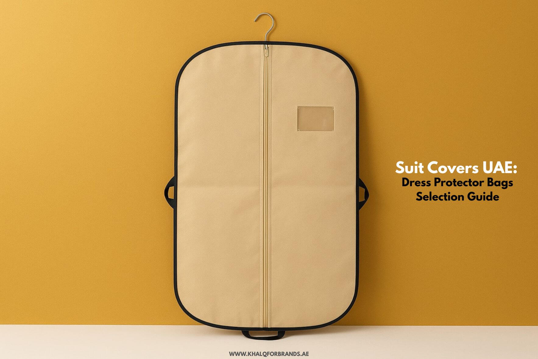 Beige suit cover bag with black edging, displayed upright against a golden-yellow background. The bag has a full-length zipper, side handles, a transparent ID window, and a hanger hook at the top. On the right side, bold black and white text reads: ‘Suit Covers UAE: Dress Protector Bags Selection Guide.’ Website address appears at the bottom.