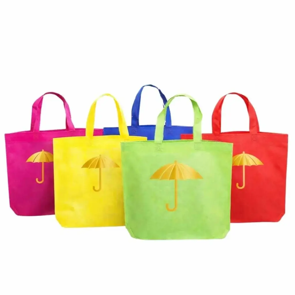 Colorful loop handle tote-style non-woven bags with gussets, printed with umbrella designs on the front, arranged side by side for custom promotional use in Dubai, UAE.