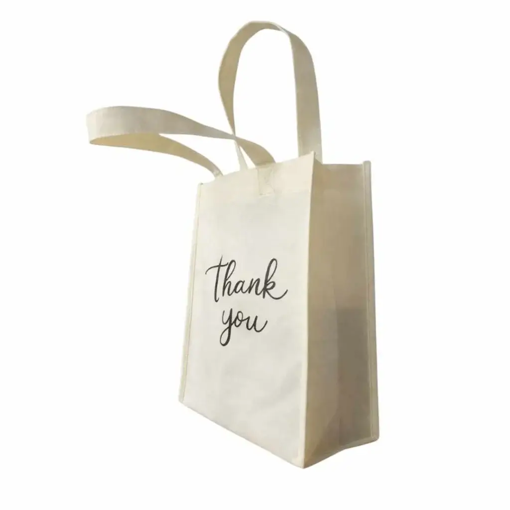 Ivory promotional non-woven bag with side gussets and loop handles, printed with the words “Thank You” on the front, designed for custom branding and giveaways in Dubai, UAE.